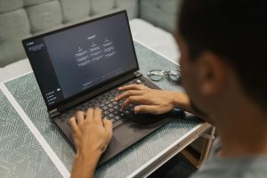 man working on laptop using AI