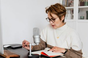 woman reading her writing with microphone