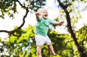 laughing baby being thrown in the air