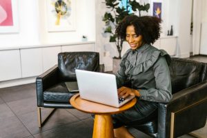 black woman at laptop in lounge