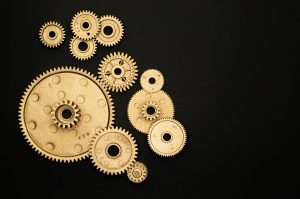 varying sized gold gears connecting