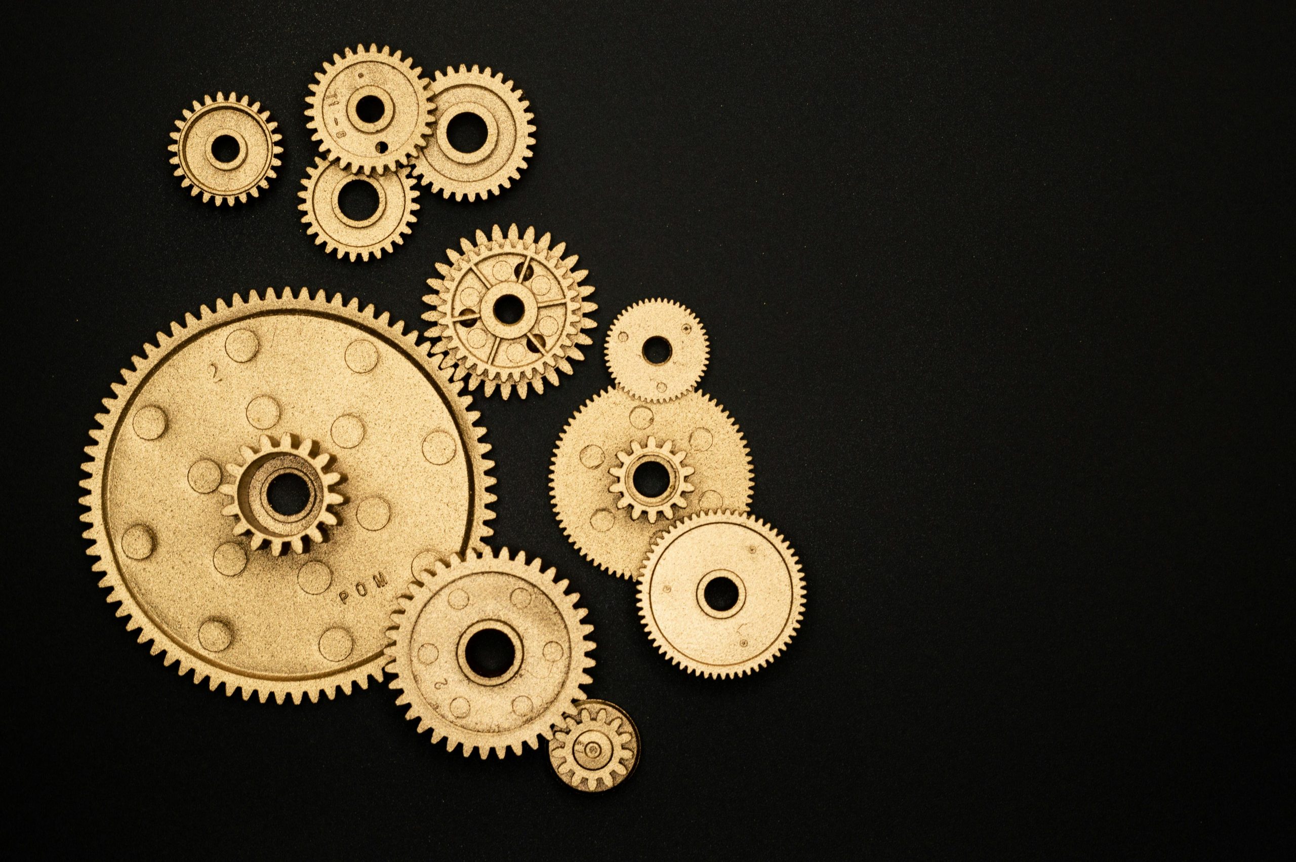 varying sized gold gears connecting