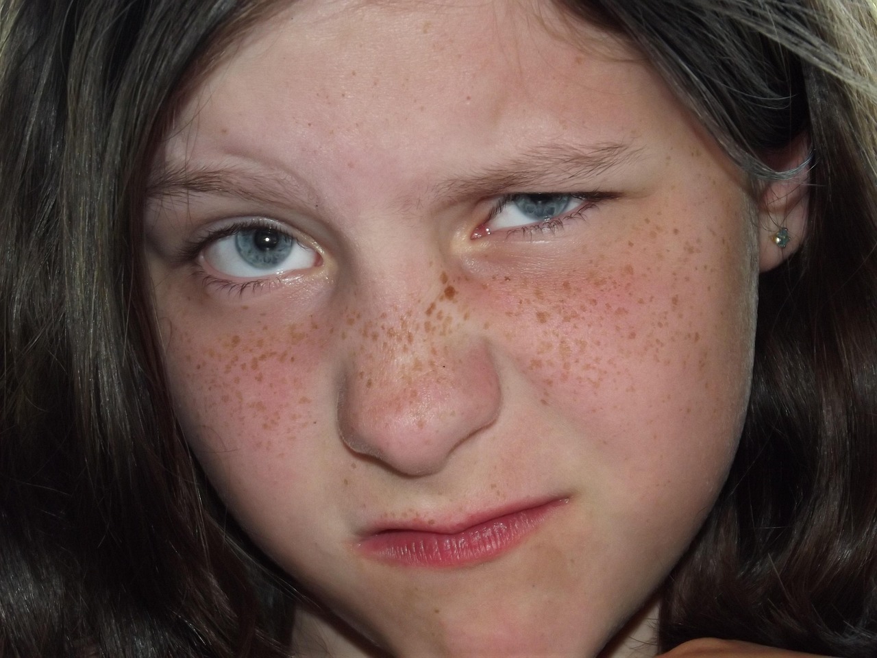 closeup of girl with scrunched up face