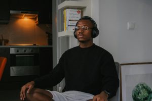 black man meditating with headphones